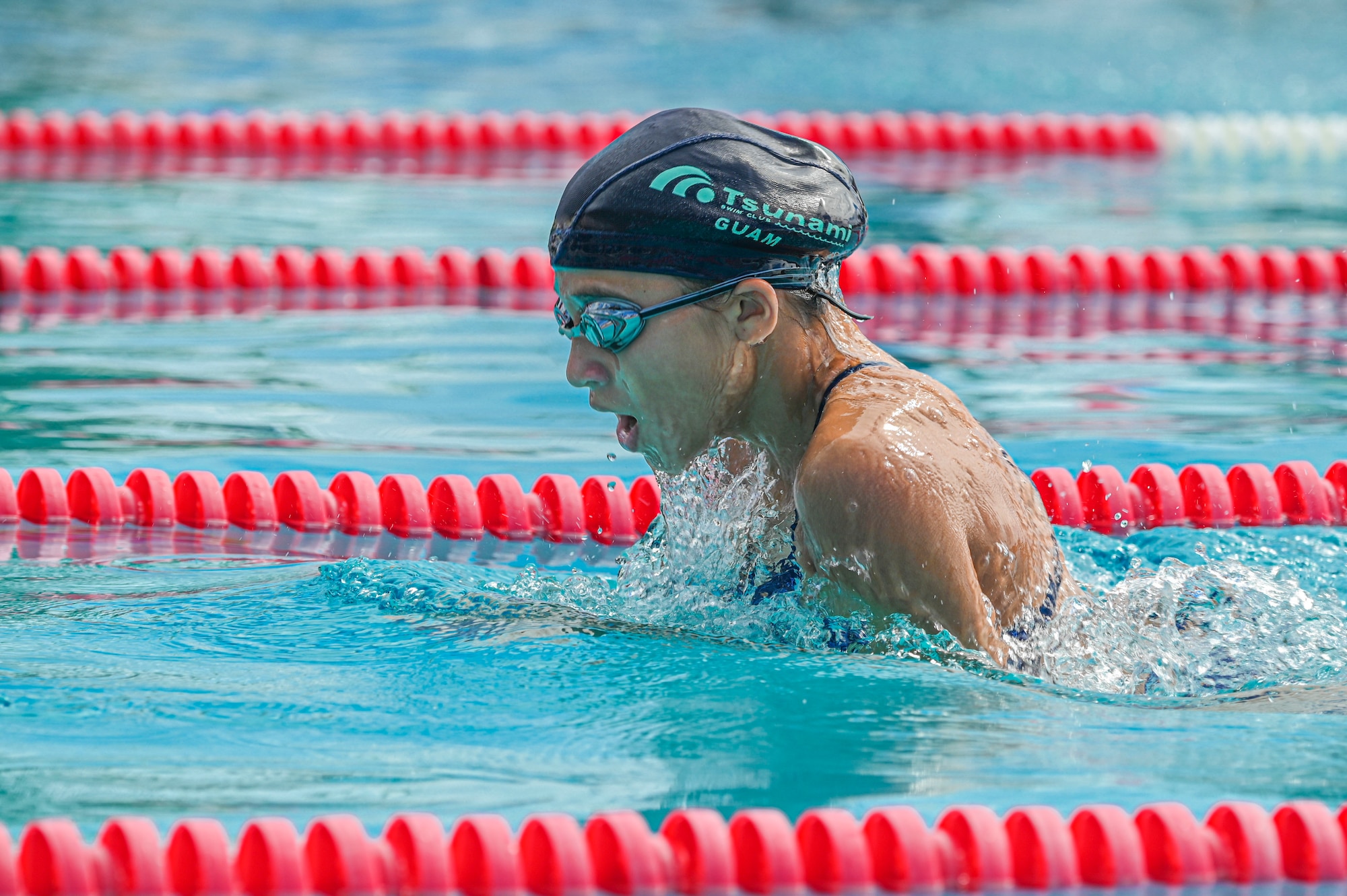 a swimmer swims breastroke.