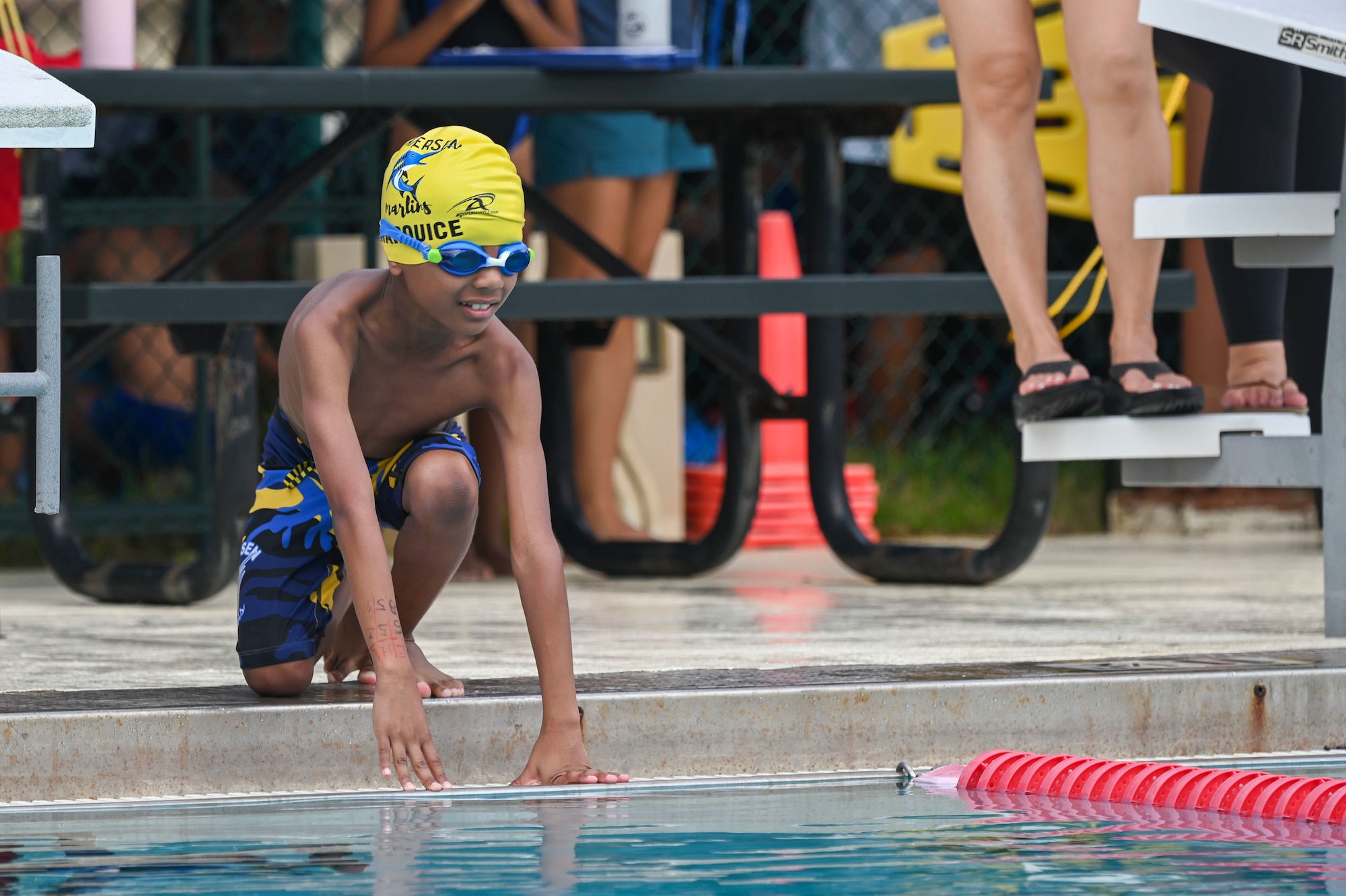 A swimmer prepares to dive into a pool