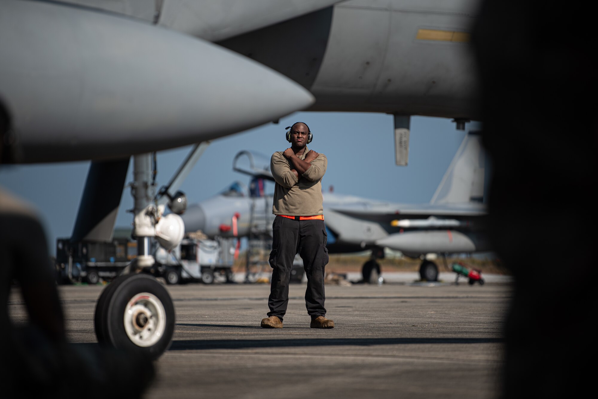 Maintainer prepares to marshal a jet.