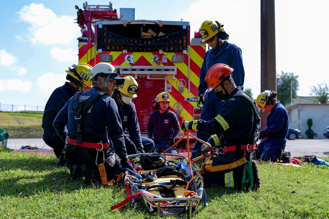 Firefighters with Marine Corps Installations Pacific Fire and Emergency Services participate in embankment rope training on Camp Foster, Okinawa, Japan, Sept. 28, 2022. The firefighters utilized roping techniques to rescue and provide care to a simulated victim located at the bottom of a steep embankment. MCIPAC F&ES is a regional fire department that operates eight fire stations across Japan and provides services to installations including fire suppression, technical rescue, hazardous material disposal, emergency medical care, fire protection and prevention. (U.S. Marine Corps photo by Lance Cpl. Tyler Andrews)