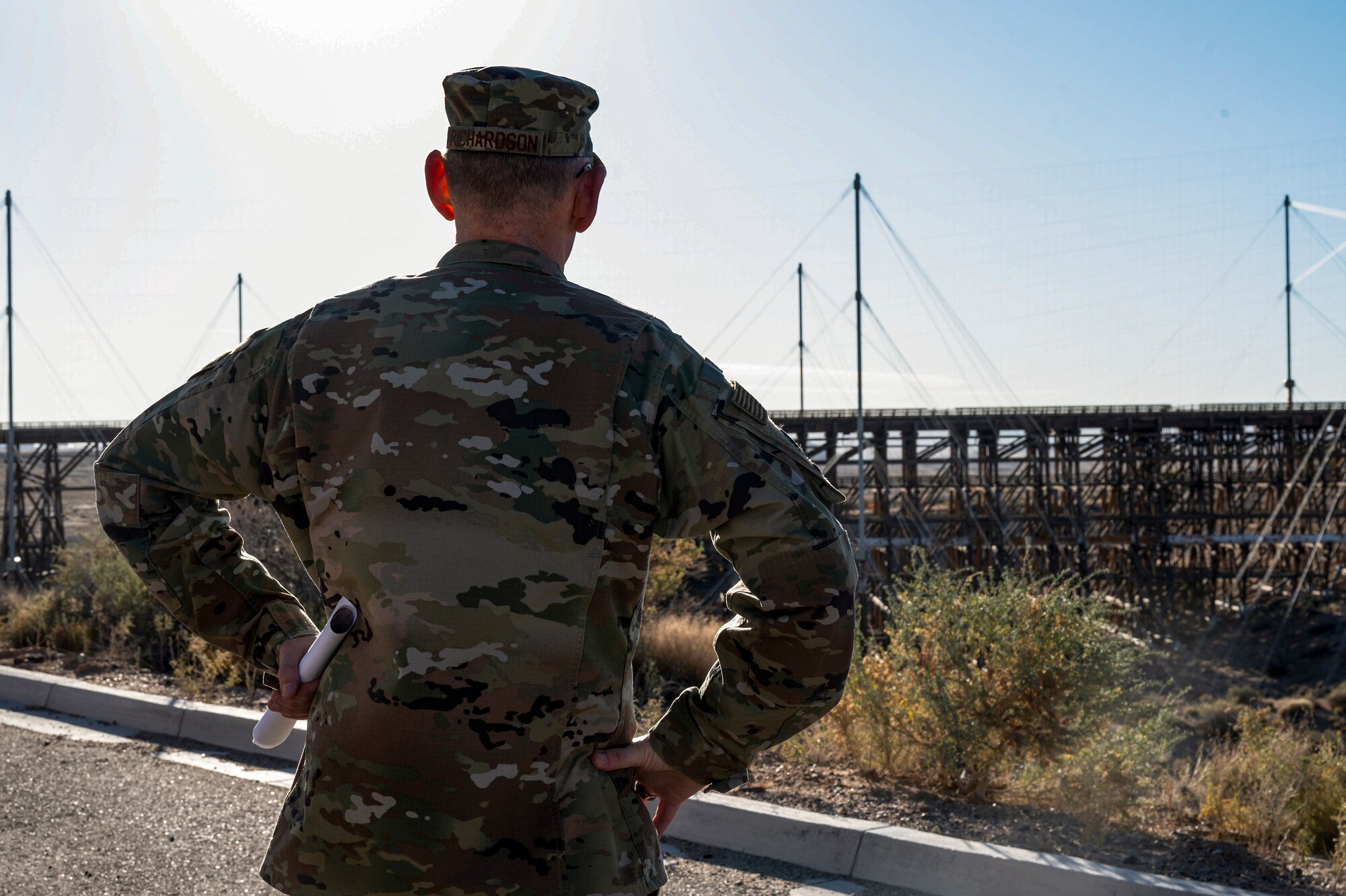 A man stares at the trestle.