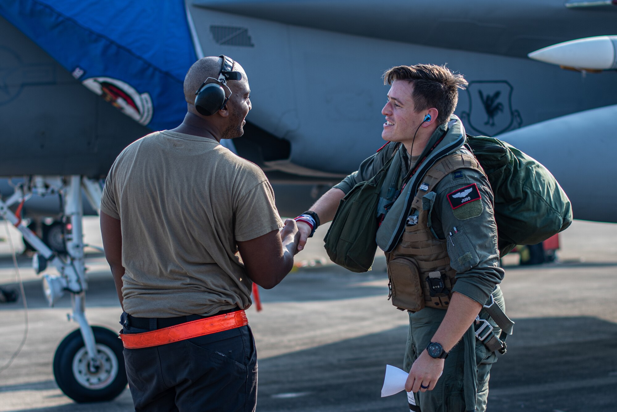 Pilot shakes hands with a maintainer.