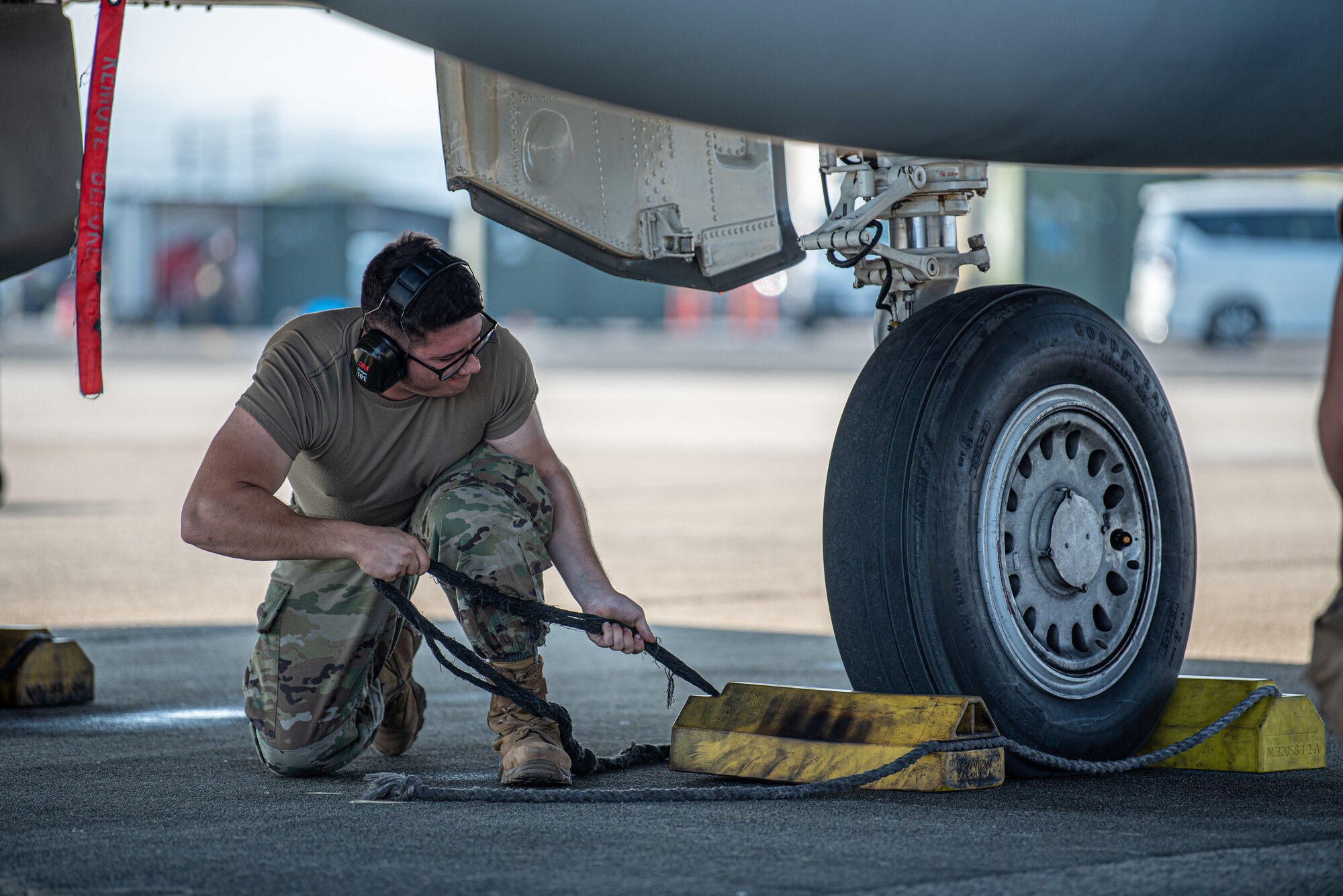 Airman removes chocks before a flight.