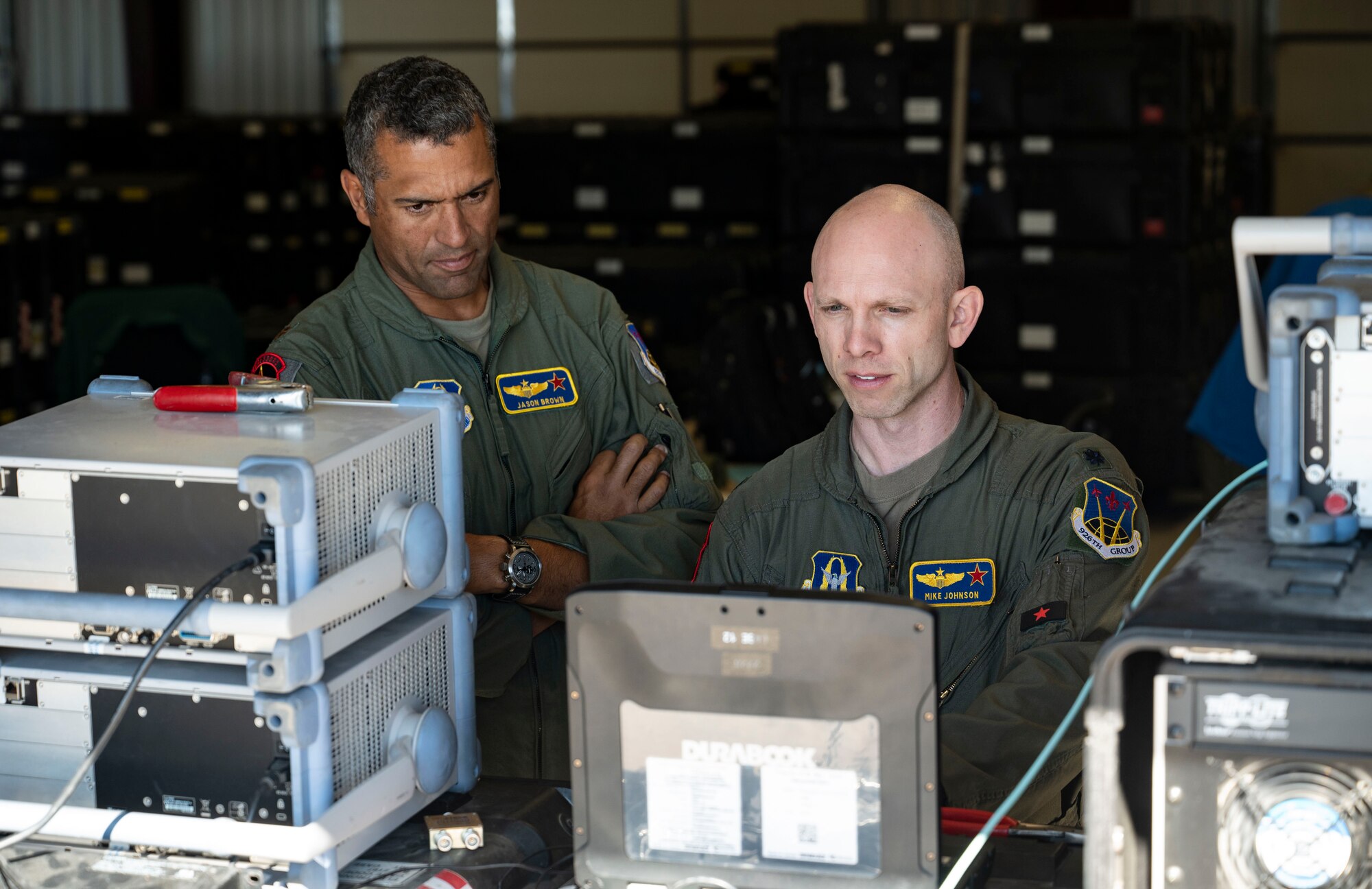 U.S. Air Force Maj. Jason Brown, left, and Lt. Col. Mike Johnson, right, both 26th Space Aggressor Squadron space control operators, internally verify a satellite signal is being built correctly before broadcasting during a CRIMSON SKIES exercise