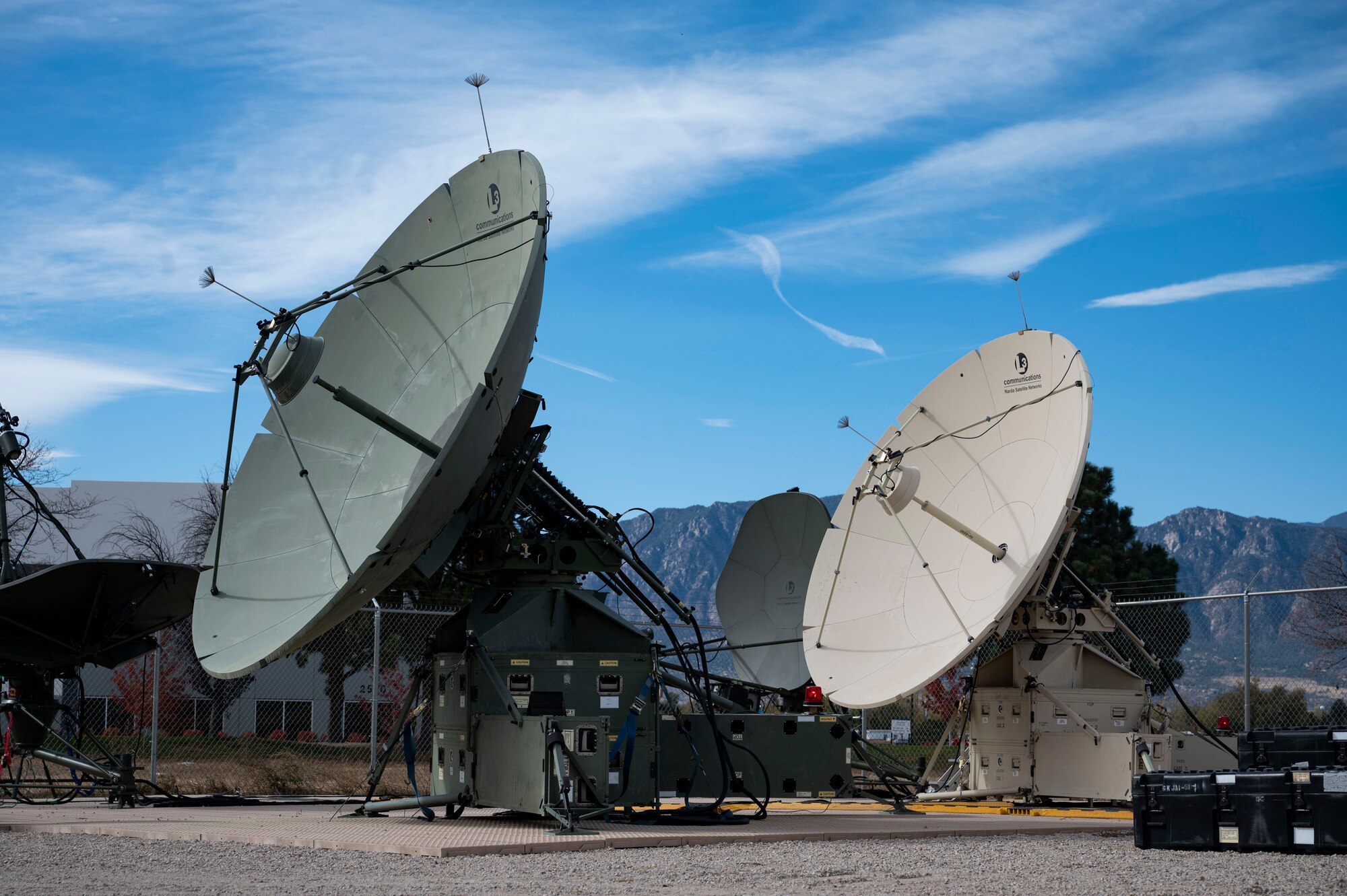 The Quad-band Large Aperture Antenna (QLAA) and Ground Multi-band Terminal (GMT) satellite dishes are used by space range operators during a CRIMSON SKIES exercise