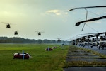 Four helicopters prepare to land.