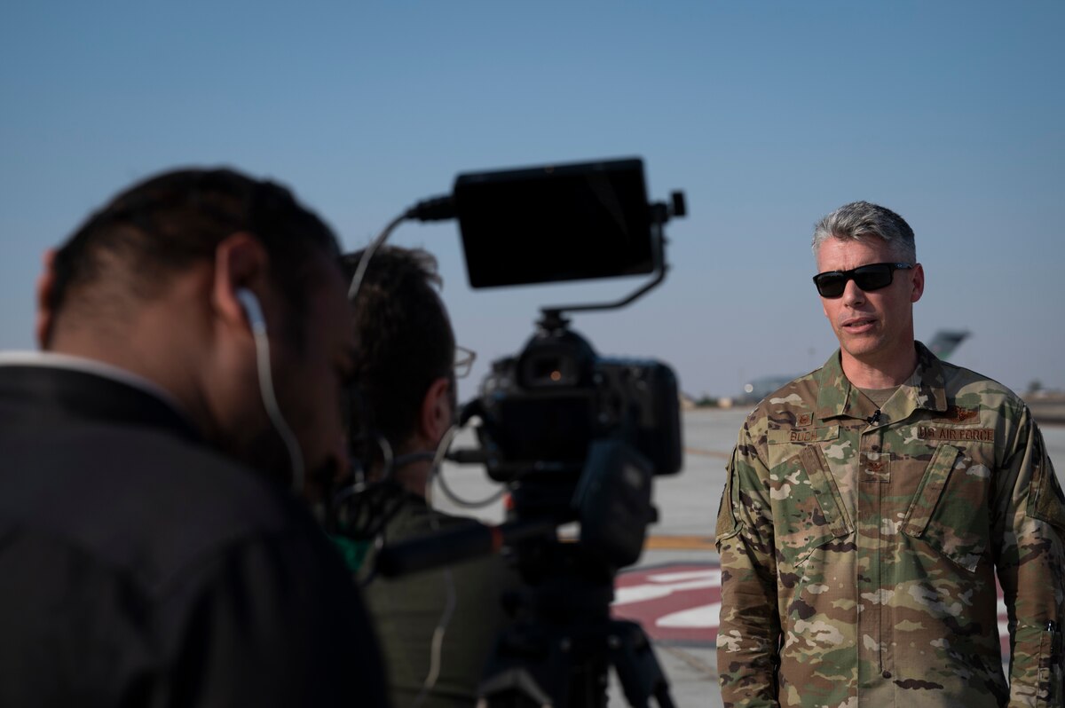From right, U.S. Air Force Col. George Buch Jr., 386th Air Expeditionary Wing commander, gives an interview to Mohamed Abdalla Malek Abdalla, Associated Press journalist, and Dani Noureddin, Associated Press journalist, at Ali Al Salem Air Base, Kuwait, Nov. 14, 2022. Journalists were invited to the installation to see how the 386th AEW projects combat air power and logistical support throughout the region while advancing the Air Force’s enduring presence here. (U.S. Air Force photo by Staff Sgt. Dalton Williams)
