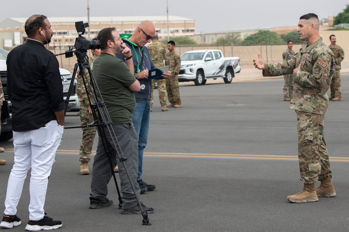 From right, U.S. Air Force Senior Master Sgt. Andrew Silkworth, 386th Expeditionary Logistics Readiness Squadron aerial port superintendent, gives an interview to Associated Press and Al Jaridai journalists during a media event at Ali Al Salem Air Base, Kuwait, Nov. 14, 2022. Silkworth spoke to the journalists about the aerial port’s role in the 386th AEW mission and how they helped bring relief aid to Pakistan in the form of 140-thousand pounds of humanitarian supplies. (U.S. Air Force photo by Staff Sgt. Ashley N. Mikaio)