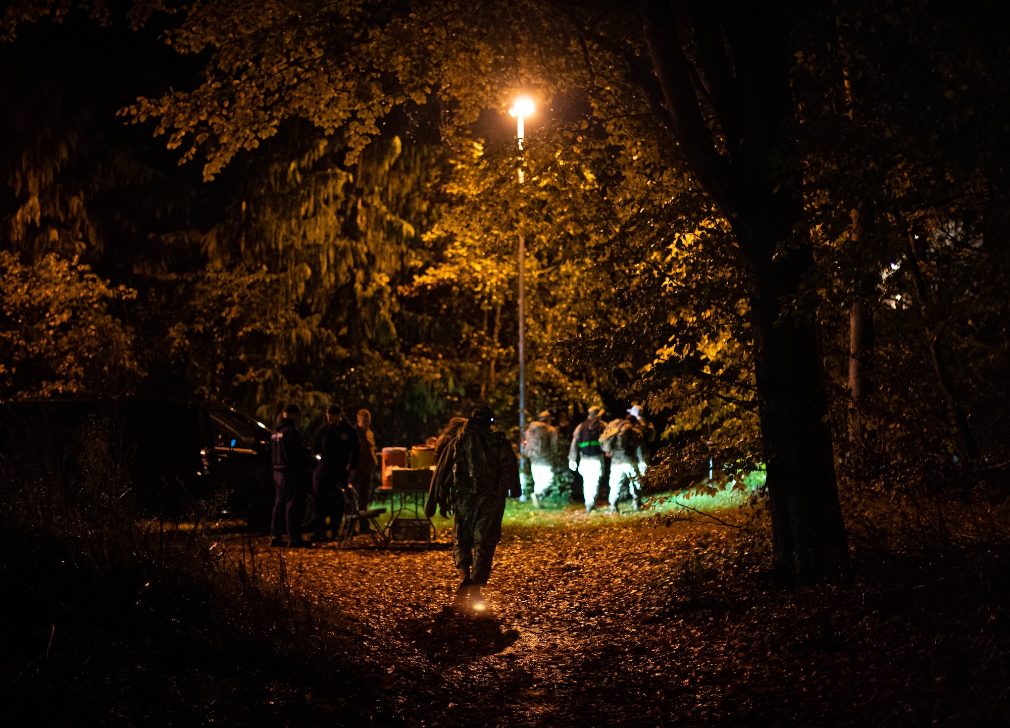 Members of Kaiserslautern Military Community walk by a refreshment stand during the Norwegian Foot March at Ramstein Air Base, Germany, Nov. 5, 2022. The Norwegian Foot March was introduced to the Norwegian armed forces in 1915 as a culminating training event for new conscripts and infantry soldiers. Traditionally, the event simulated overnight movement by a dismounted light infantry element with the objective to seize attack positions. (U.S. Air Force photo by Airman 1st Class Jared Lovett)