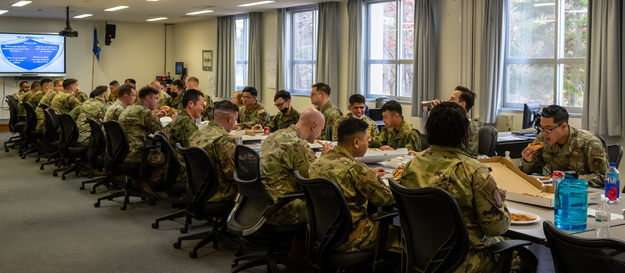 Japan Ground Self-Defense Force soldiers eat lunch with Airman Leadership School (ALS) students as part of Camp Sendai’s Basic English Training Course tour at Misawa Air Base, Japan, Nov. 8, 2022.