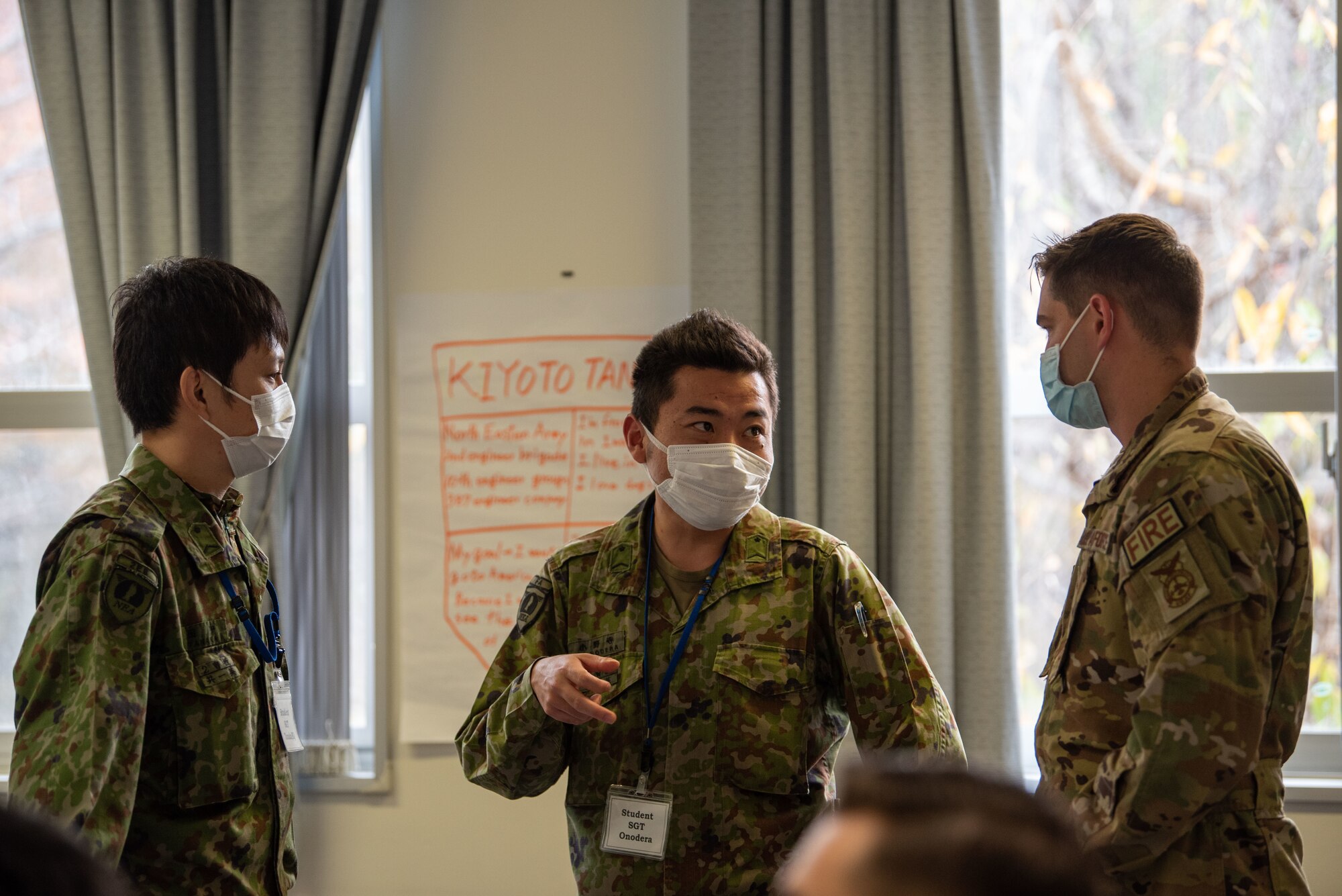 A U.S. Airman and Japan Ground Self-Defense Force (JGSDF) soldiers talk about their jobs during Camp Sendai’s Basic English Training Course tour of the Airman Leadership School at Misawa Air Base, Japan, Nov. 8, 2022.