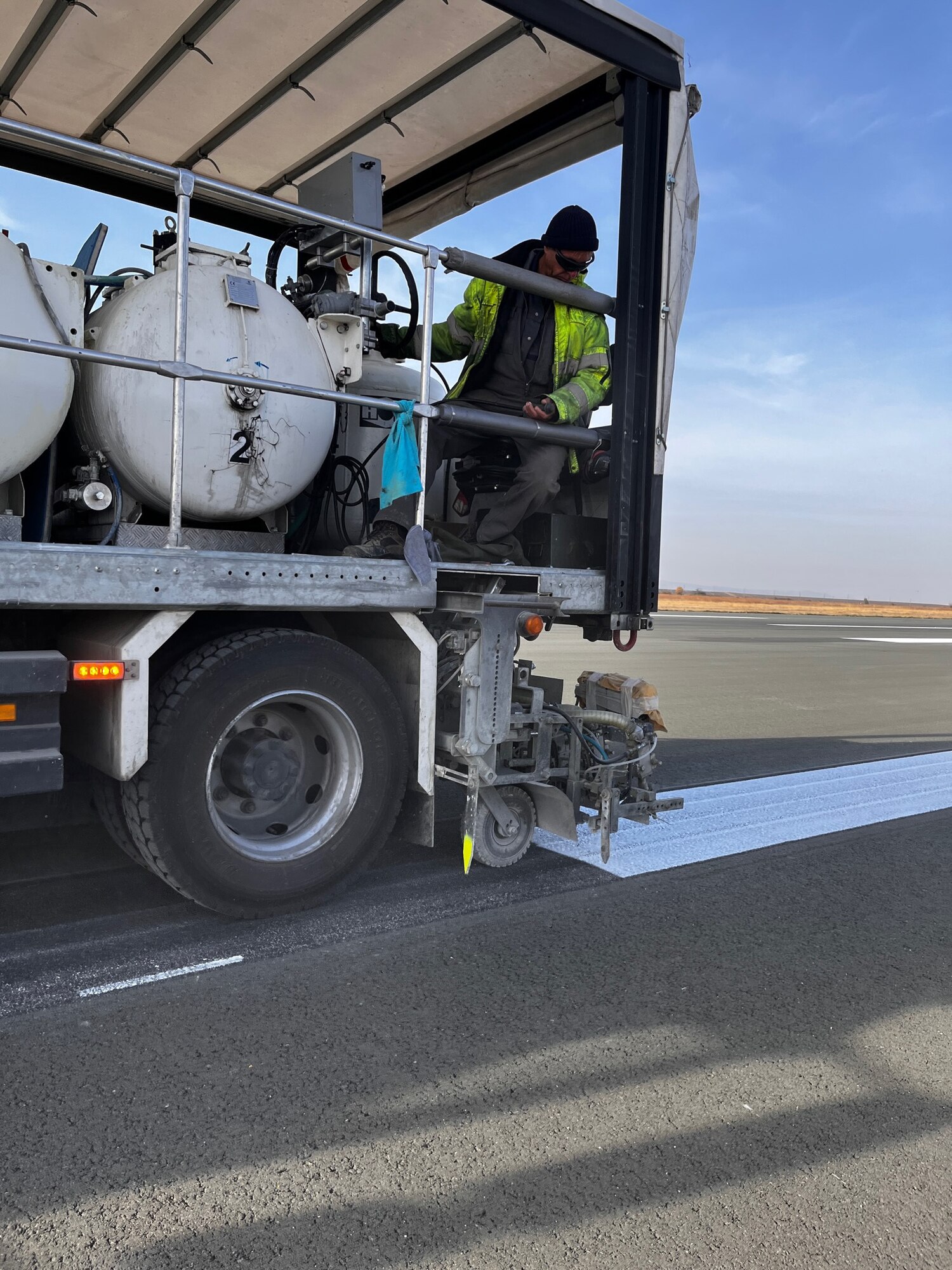 A local national assigned to the 435th Construction and Training Squadron re-stripes the runway at Bezmer Air Base, Bulgaria, Oct. 25, 2022.