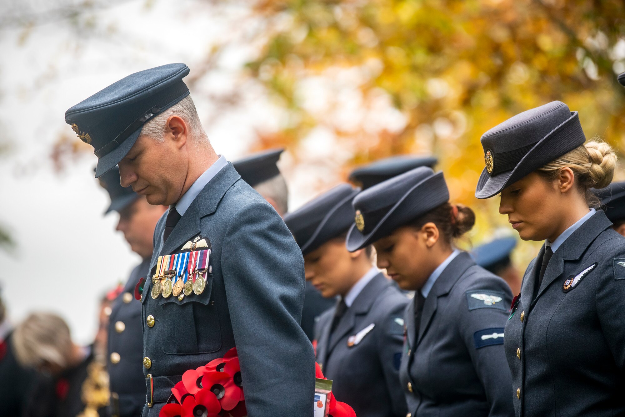 Members of the Royal Air Force bow their heads during a Remembrance Day ceremony at RAF Welford, England, Nov. 10, 2022. Airmen from the 501st Combat Support Wing, RAF, and distinguished guests came together to honor the sacrifices of armed forces veterans, past and present. (U.S. Air Force photo by Staff Sgt. Eugene Oliver)
