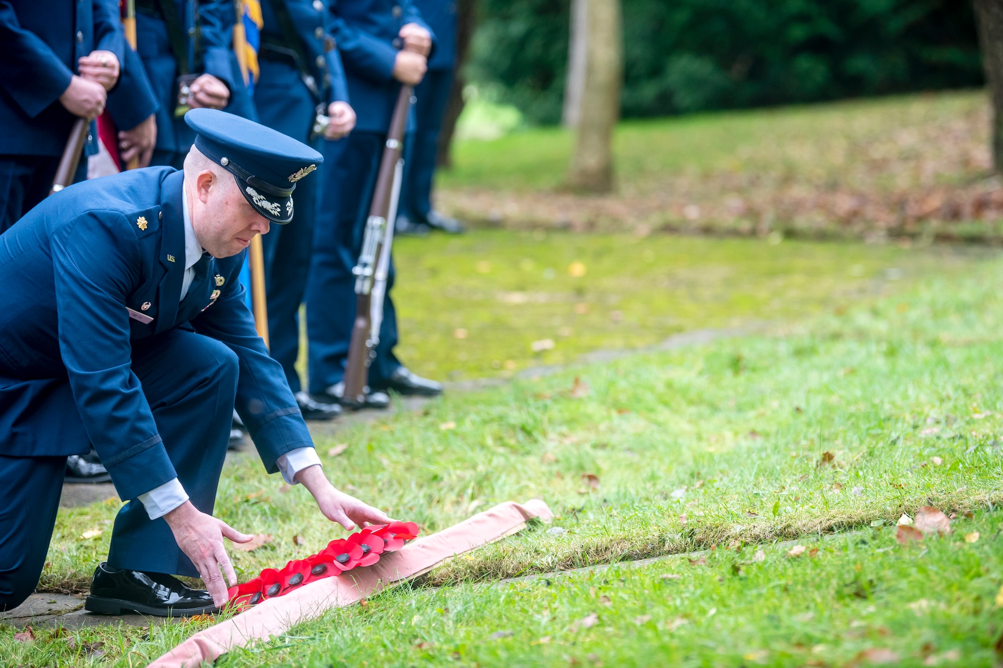 U.S. Air Force Maj. Preston Smith, 420th Munitions Squadron commander, lays a wreath during a Remembrance Day Ceremony at RAF Welford, England, Nov. 10, 2022. Airmen from the 501st Combat Support Wing, Royal Air Force, and distinguished guests came together to honor the sacrifices of armed forces veterans, past and present. (U.S. Air Force photo by Staff Sgt. Eugene Oliver)