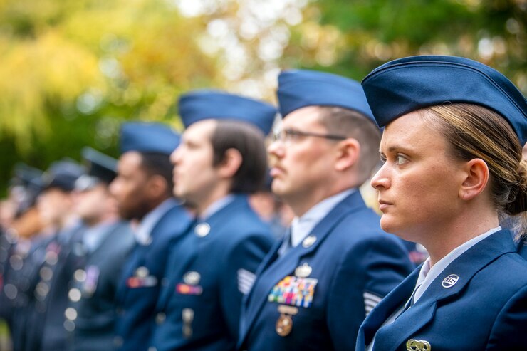 Airmen stand side-by-side in their dress uniform