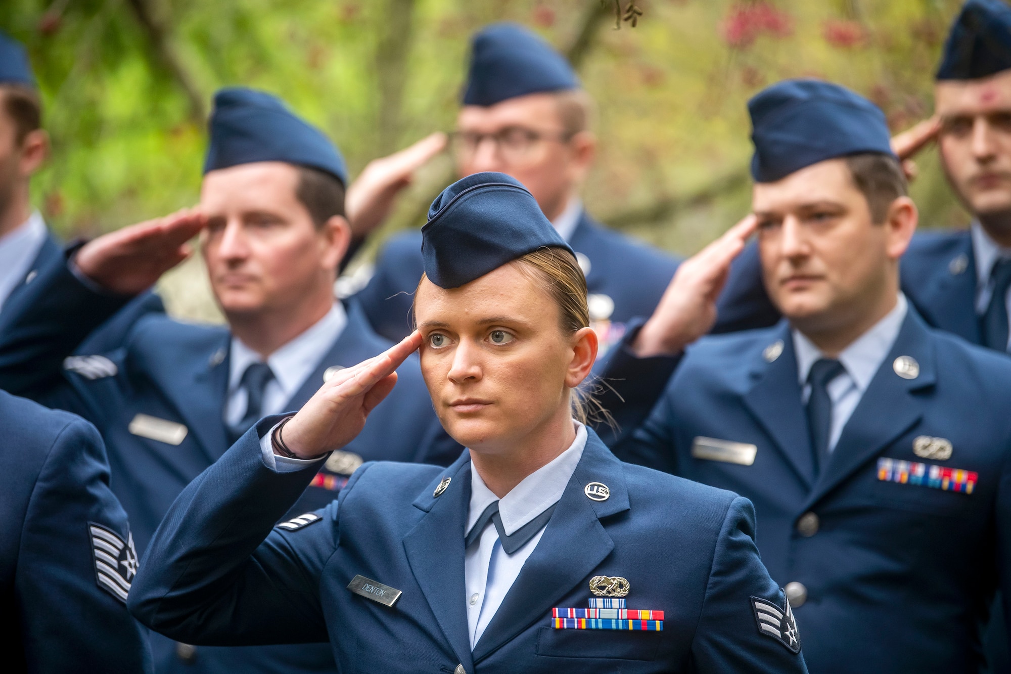 Airmen from the 420th Munitions Squadron, salute during a Remembrance Day ceremony at RAF Welford, England, Nov. 10, 2022. Airmen from the 501st Combat Support Wing, Royal Air Force, and distinguished guests came together to honor the sacrifices of armed forces veterans, past and present. (U.S. Air Force photo by Staff Sgt. Eugene Oliver)