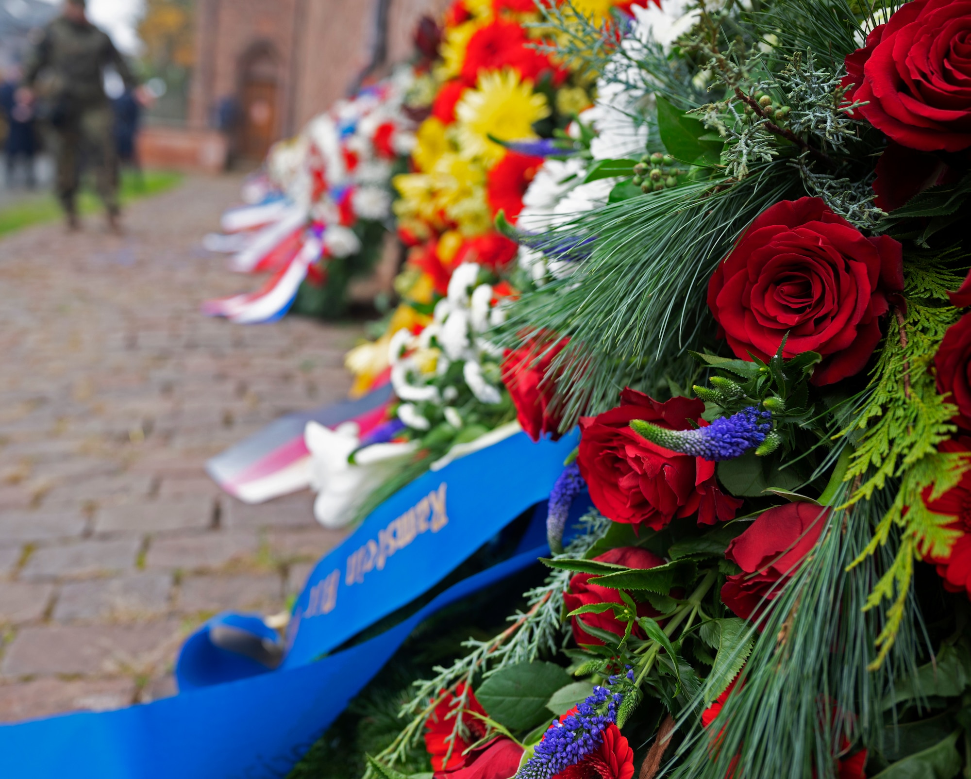 A wreath sits against a wall during a ceremony commemorating the National Day of Mourning in the Union Community of Ramstein-Miesenbach, Germany, Nov. 13, 2022. The Nation Day of Mourning is a German holiday held on the 33rd Sunday of the year, to honor those who have died because of war or victims of violent oppression from all nations. (U.S. Air Force photo by Senior Airman Thomas Karol)