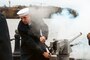 Seaman Travis Nelson of the U.S. Navy Ceremonial Guard fires a single round during a 21 gun salute ceremony held onboard the Washington Navy Yard.