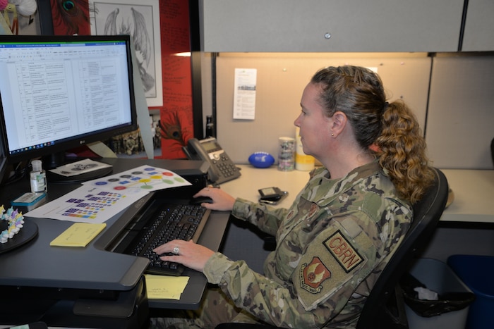 Master Sgt. Misty Guevara Zavala working at a computer
