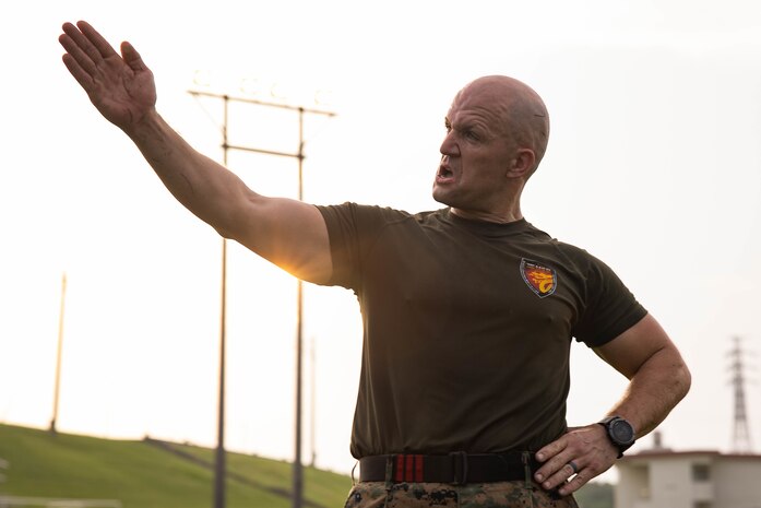 U.S. Marine Corps 1st Sgt. Daniel Best, company first sergeant of Headquarters Service Company, III Marine Expeditionary Force Support Battalion, III Marine Expeditionary Force, instructs Marines during a field meet on Camp Courtney, Okinawa, Japan, July 28, 2022. The Marines competed in various activities such as pull-ups, sprints, and fireman carries to boost camaraderie and morale in the unit.