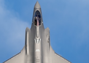 The nose of a jet points up in the sky
