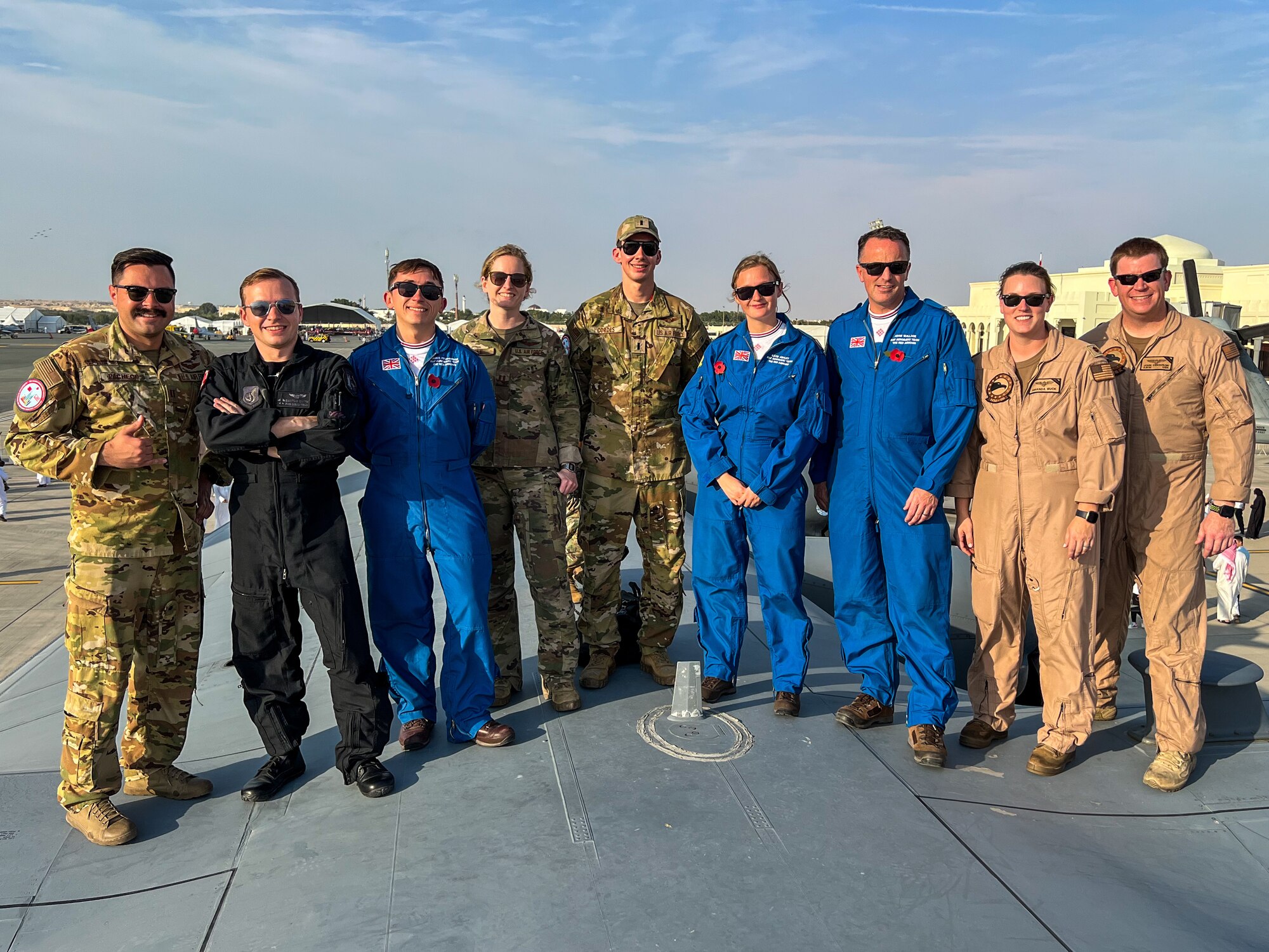 U.S. Air Force and Royal Air Force service members pose for a photo during the Bahrain International Airshow (BIAS), at Sakhir Airbase, Bahrain Nov. 11, 2022. The airshow showcased how U.S. forces work together with our partner nations and reassure our coalition and regional partners of our continued commitment to the security and stability of the region. (U.S. Air Force photo by Capt. Kayshel Trudell)