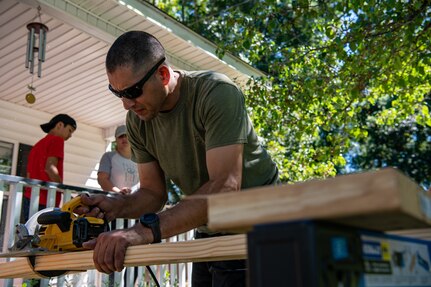 Master Sgt. Cesar Alvarado cuts a piece of wood.