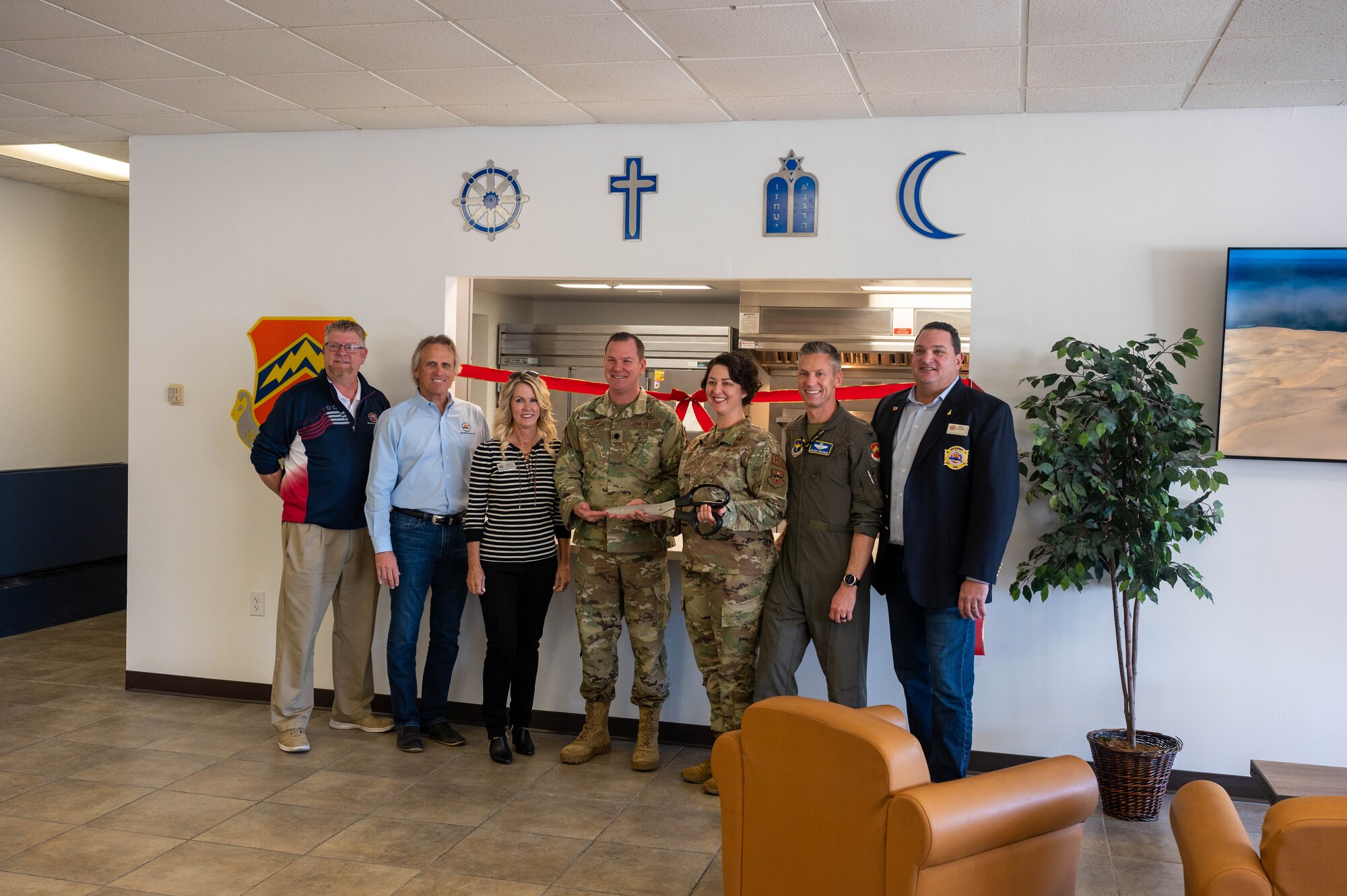 U.S. Air Force Airmen from  the 56th Fighter Wing and community members participate in the chapel kitchen ribbon-cutting ceremony Nov. 8, 2022, at Luke Air Force Base, Arizona.