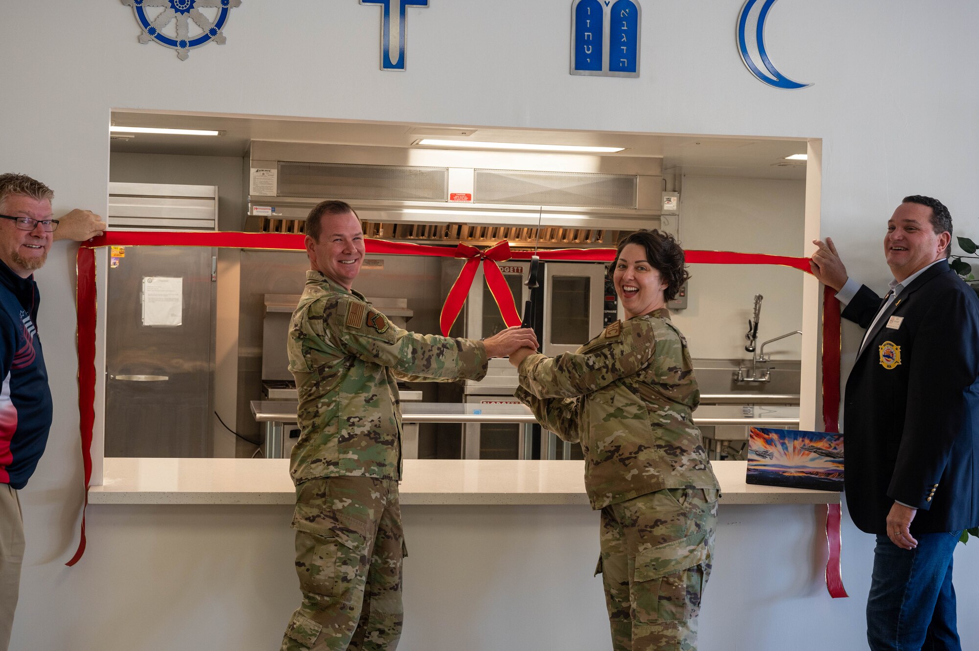 U.S. Air Force Lt. Col. Raymond Boyer, 56th Fighter Wing chaplain, and Master Sgt. Aimee Roth, 56th FW religious affairs superintendent, cut the ribbon during the chapel kitchen ribbon-cutting ceremony Nov. 8, 2022, at Luke Air Force Base, Arizona.