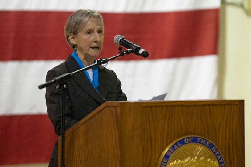 Alison Carter, 2022 Governor's Veterans Advocacy Award recipient, describes her work in the Fairbanks Veterans Court and encourages the audience to take part in veteran advocacy during the Department of Military and Veterans Affairs Veterans Day ceremony held at the National Guard Armory on Joint Base Elmendorf-Richardson, Alaska, Nov. 11, 2022. The ceremony included speeches from key speakers, Fallen Warrior ceremony, presentation of commemorative wreaths, and moment of silence for those who have fallen. (Alaska National Guard photo by Victoria Granado)