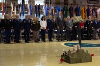 Service members, veterans, family members, and distinguished visitors take a moment of silence at the conclusion of the Department of Military and Veterans Affairs Veterans Day ceremony held at the National Guard Armory on Joint Base Elmendorf-Richardson, Alaska, Nov. 11, 2022. The ceremony included speeches from key speakers, Fallen Warrior ceremony, presentation of commemorative wreaths, and moment of silence for those who have fallen. (Alaska National Guard photo by Victoria Granado)