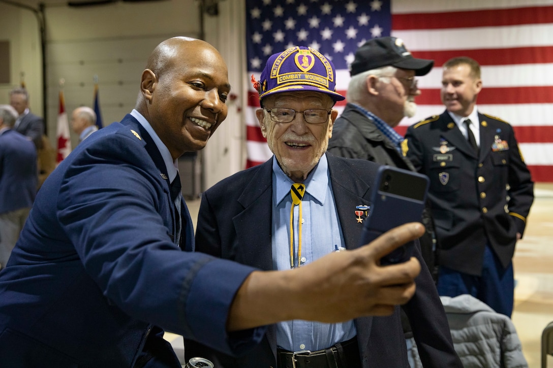 U.S. Air Force Maj. Damon Jackson, Alaska National Guard provost marshal, left, meets Gordon Severson, a Korean War veteran, after the conclusion of the Department of Military and Veterans Affairs Veterans Day ceremony held at the National Guard Armory on Joint Base Elmendorf-Richardson, Alaska, Nov. 11, 2022. The ceremony included speeches from key speakers, Fallen Warrior ceremony, presentation of commemorative wreaths, and moment of silence for those who have fallen. (Alaska National Guard photo by Victoria Granado)
