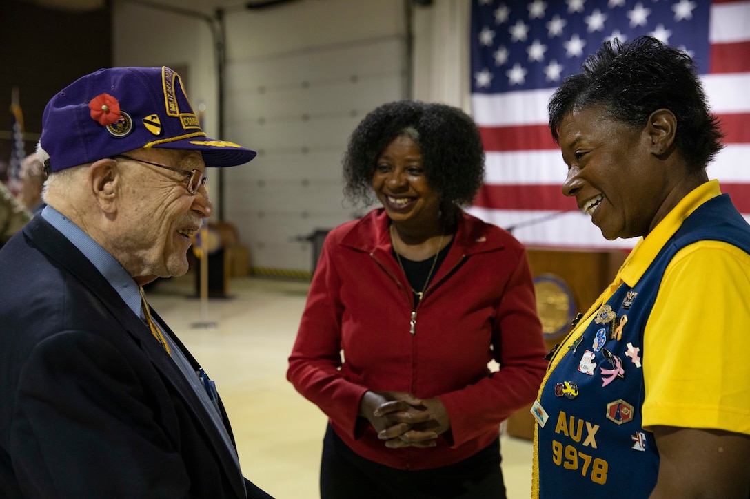 Gordon Severson, a Korean War veteran, left, talks with Dawn Bundick, president, right, and Carolyn Kearney-Corey, senior vice president, both with the Jon Art Noyes Veterans of Foreign Wars Post 9978, after the conclusion of the Department of Military and Veterans Affairs Veterans Day ceremony held at the National Guard Armory on Joint Base Elmendorf-Richardson, Alaska, Nov. 11, 2022. The ceremony included speeches from key speakers, Fallen Warrior ceremony, presentation of commemorative wreaths, and moment of silence for those who have fallen. (Alaska National Guard photo by Victoria Granado)