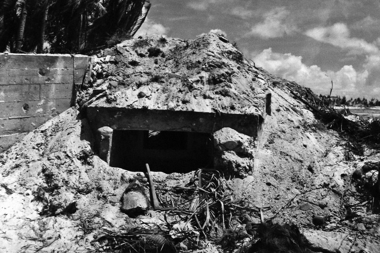 A small opening leads into a bunker covered in sand.