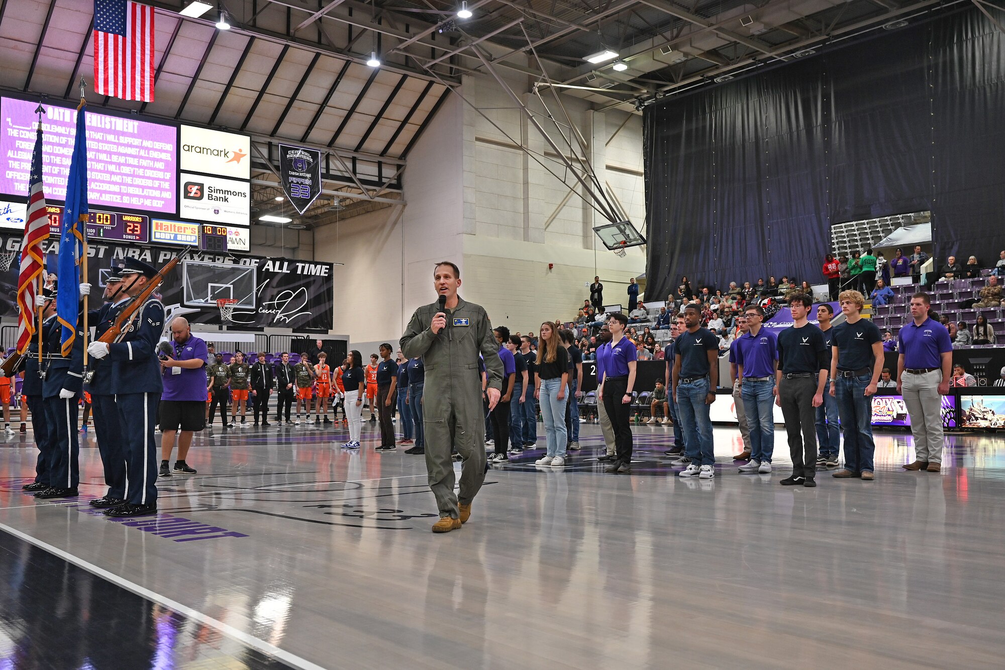 new members are sworn into the military on a basketball court during halftime