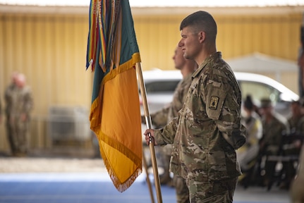 A guidon bearer from the Wisconsin Army National Guard's 157th Maneuver Enhancement Brigade holds the unit's colors during a transfer of authority ceremony at Camp Lemonnier, Djibouti, Nov. 5, 2022.