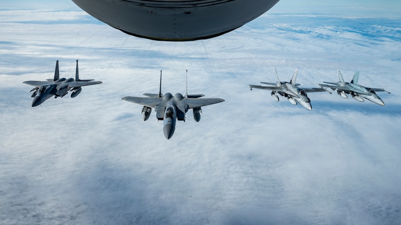Under the direction of the North American Aerospace Defense Command (NORAD), two F-15s assigned to the Massachusetts Air National Guard and two CF-18 assigned to the Royal Canadian Air Force fly in formation behind a KC-135 assigned to the Pennsylvania Air National Guard during air-defense Operation NOBLE DEFENDER, Oct. 27, 2022.
