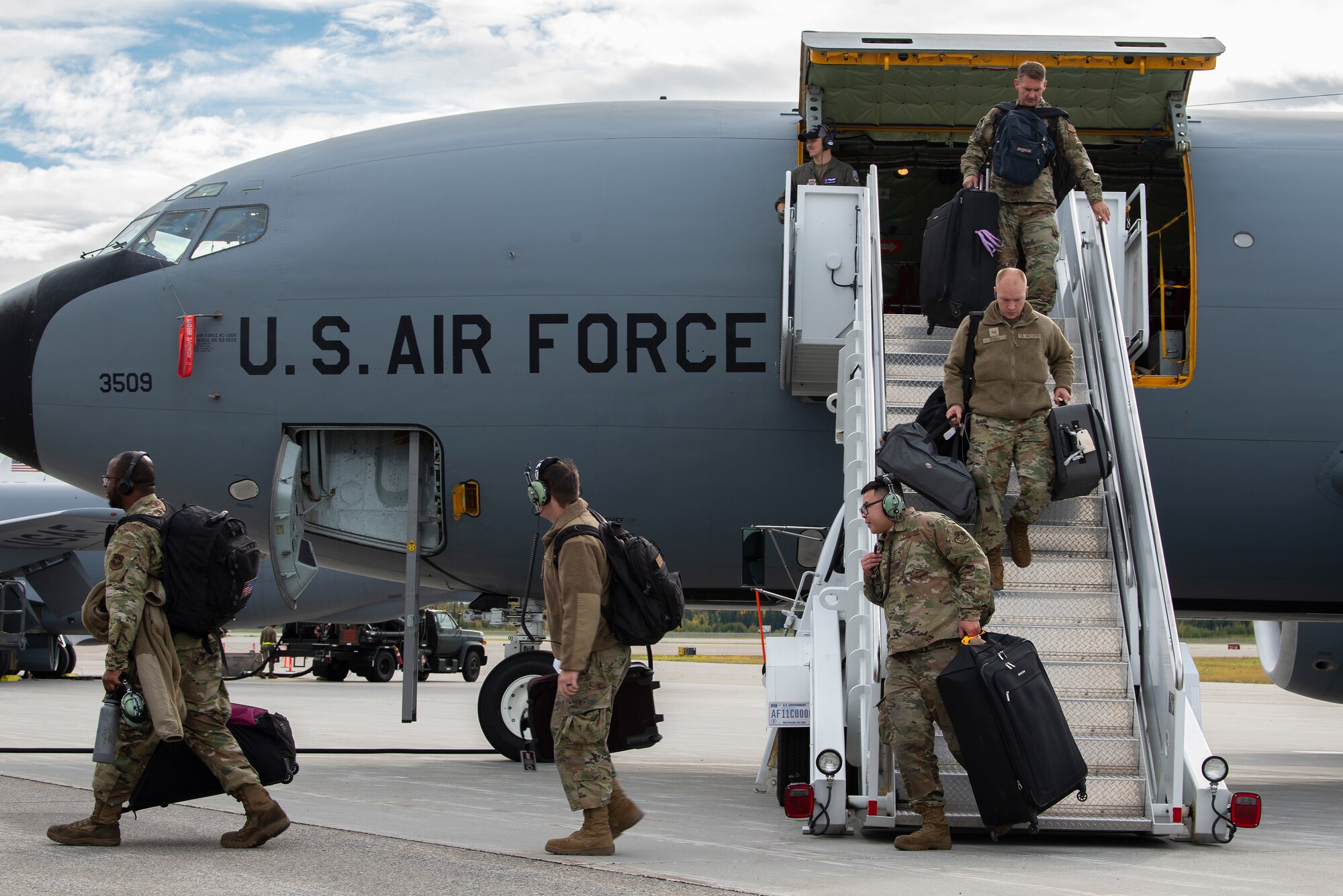 Airmen depart a KC-135