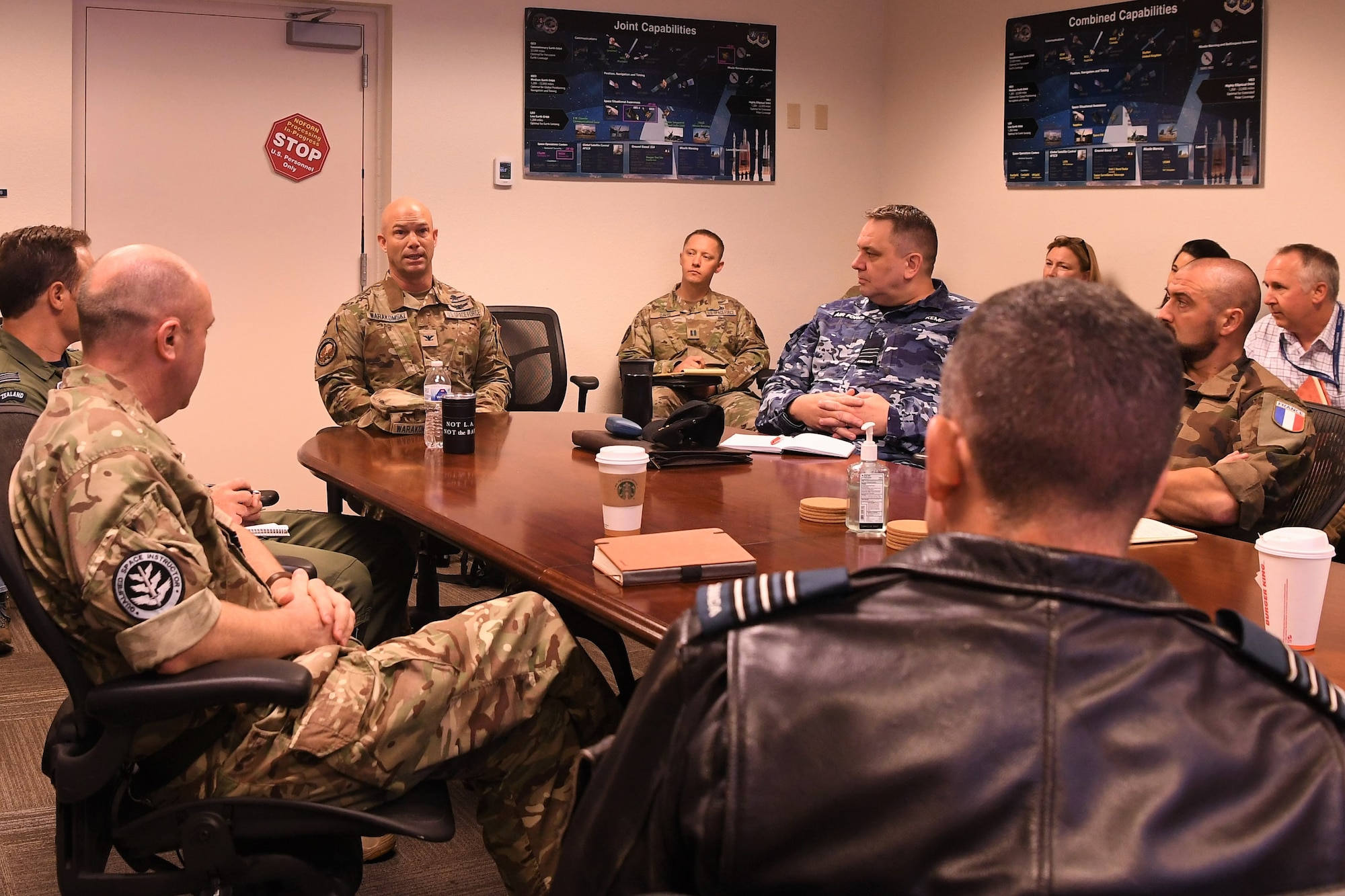 U.S. Space Force Col. Shay Warakomski, Combined Force Space Component Command deputy commander, middle, welcomes participants in the Combined Space Operations Center mission analysis held from Oct. 31 – Nov. 4, 2022, at Vandenberg Space Force Base, Calif. This was the first CSpOC mission analysis conducted since the organization changed from a joint to a combined operating center. Representatives from Australia, Canada, France, Germany, New Zealand, the United Kingdom and the United States were able to provide their feedback during the five-day event. (U.S. Space Force photo by Capt. Erin Recanzone)