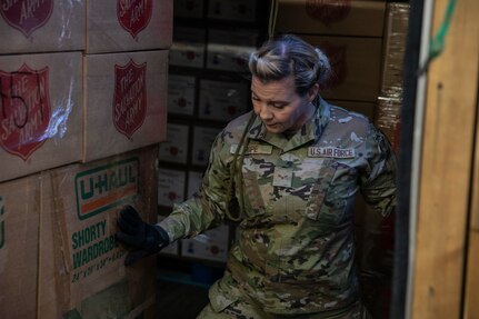 Airman 1st Class Heather Pope, a ground transportation specialist with 176th Logistics Readiness Squadron, 176th Wing guides a pallet of gifts for Operation Santa Claus onto a truck at the Salvation Army warehouse in Anchorage, Alaska, Nov. 10, 2022. Operation Santa Claus is the AKNG’s yearly community relations and support program that provides gifts to children in remote communities across the state. In its 67th year, the program will celebrate with the communities of Scammon Bay, Minto and Nuiqsuit. (Alaska National Guard photo by Staff Sgt. Katie Mazos-Vega)