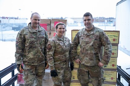 From left to right, Master Sgt. Garrick Hoehne, a logistics planner with 176th Logistics Readiness Squadron, 176th Wing, Airman 1st Class Heather Pope and Tech. Sgt. Michael Durgin, both ground transportation specialists with 176th Logistics Readiness Squadron, 176th Wing finish loading boxes of wrapped gifts on a truck at the Salvation Army warehouse in Anchorage, Alaska, to transport to Joint Base Elmendorf-Richardson for Operation Santa Claus on Nov. 10, 2022. Operation Santa Claus is the AKNG’s yearly community relations and support program that provides gifts to children in remote communities across the state. In its 67th year, the program will celebrate with the communities of Scammon Bay, Minto and Nuiqsuit. (Alaska National Guard photo by Staff Sgt. Katie Mazos-Vega)