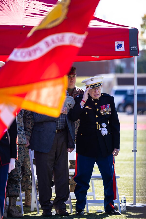 Retired U.S. Marine Corps Col. Frank W. Harris III, representing the oldest Marine during Marine Corps Base Quantico’s cake cutting ceremony, renders a salute during the presentation of the colors at Butler Stadium on MCBQ, Virginia, Nov. 9, 2022. The annual cake cutting ceremony is a long-standing tradition which celebrates the establishment of the United States Marine Corps. The Marine Corps birthday is celebrated every year to commemorate the birth of the Corps and honor the service and sacrifices of all Marines, past and present. (U.S. Marine Corps photo by Cpl. Eric Huynh)
