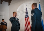 An Air Force officer in uniform salutes another Airman.