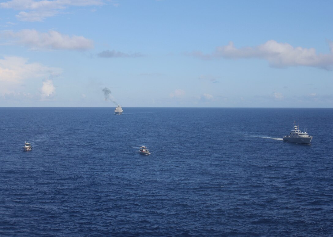 The Freedom-variant littoral combat ship USS Milwaukee (LCS 5) (rear), her 11-meter rigid inflatable boat (center), and Dominican navy vessels, Altair (GC-112) (right) and Becrux (LI-170) (left), conduct a bilateral maritime interdiction exercise off the coast of Santo Domingo, Dominican Republic November 10, 2022. Milwaukee is deployed to the U.S. 4th Fleet area of operations to support Joint Interagency Task Force South’s mission, which includes counter-illicit drug trafficking missions in the Caribbean and Eastern Pacific.