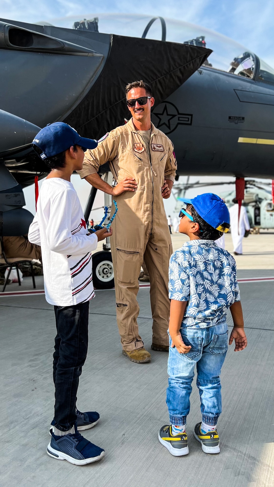 U.S. Air Force Maj. Breaux Powell, Bahrain International Airshow (BIAS), maintenance boss, answers questions from patrons during BIAS at Sakhir Airbase, Bahrain Nov. 11, 2022. The airshow showcased how U.S. forces work together with our partner nations and reassure our coalition and regional partners of our continued commitment to the security and stability of the region. (U.S. Air Force photo by Capt. Kayshel Trudell)