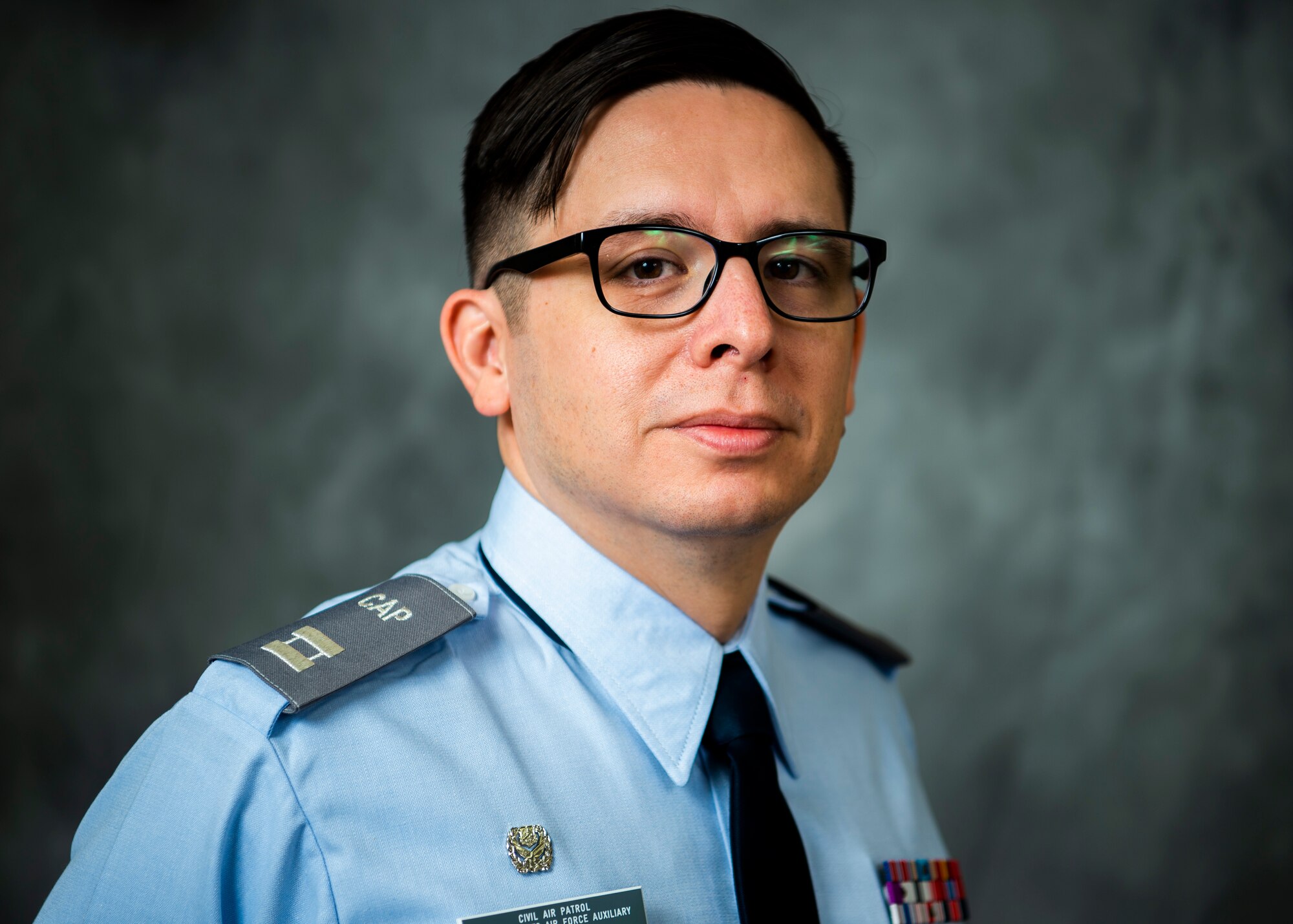 U.S. Air Force Tech. Sgt. Jeffrey MacHott, Civil Air Patrol (CAP) member, poses for photos at Misawa Air Base, Japan, Nov. 15, 2022. MacHott joined the CAP Geospatial Team that allows individuals to remotely provide damage assessment services for emergency management agencies.