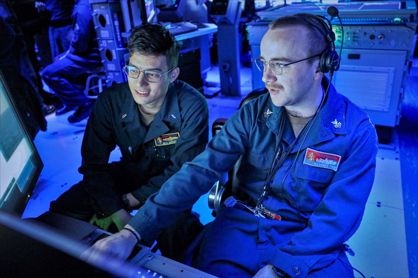 PHILIPPINE SEA (Nov. 8, 2022) Lt. j.g. Niles VanTassell, from Marietta, Georgia, and Operations Specialist 1st Class Alexander Polk, from Nashville, Tennessee, monitor surface contacts from the combat information center (CIC) aboard Arleigh Burke-class guided-missile destroyer USS Benfold (DDG 65) during a joint bilateral anti-submarine exercise, part of Keen Sword in the Philippine Sea, Nov. 8. Keen Sword is a biennial, joint and bilateral field-training exercise involving U.S. military and Japan Self-Defense Force personnel, designed to increase readiness and interoperability while strengthening the ironclad Japan-U.S. alliance. (U.S. Navy photo by Mass Communication Specialist 2nd Class Arthur Rosen)