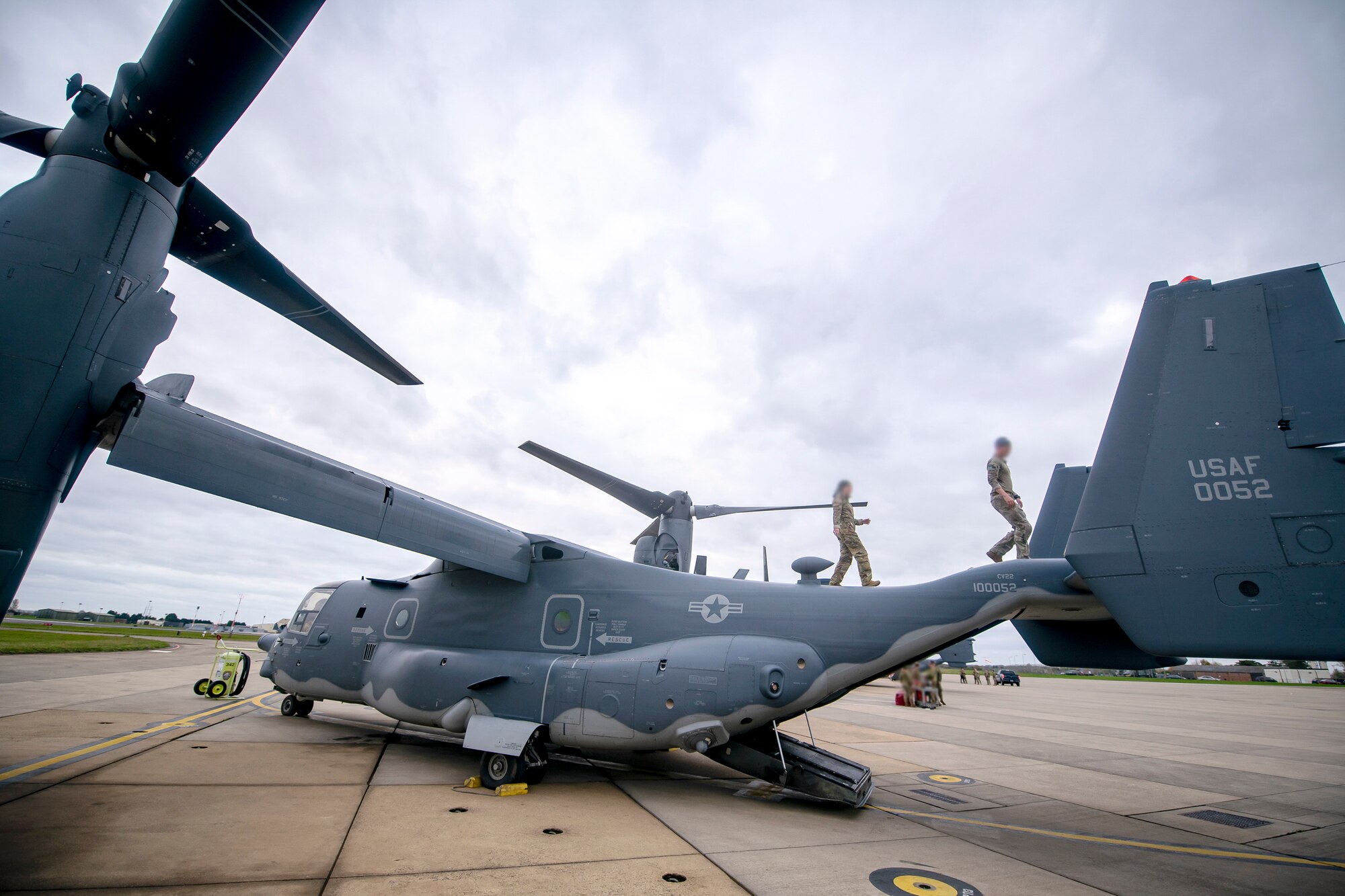 Airmen from the 352d Special Operations Wing inspect a CV-22B Osprey at RAF Mildenhall, England, Nov. 11, 2022. The 352d SOW were preparing to conduct a flyover for the annual Veterans Day ceremony at Cambridge American Cemetery and Memorial. (U.S. Air Force photo by Staff Sgt. Eugene Oliver)