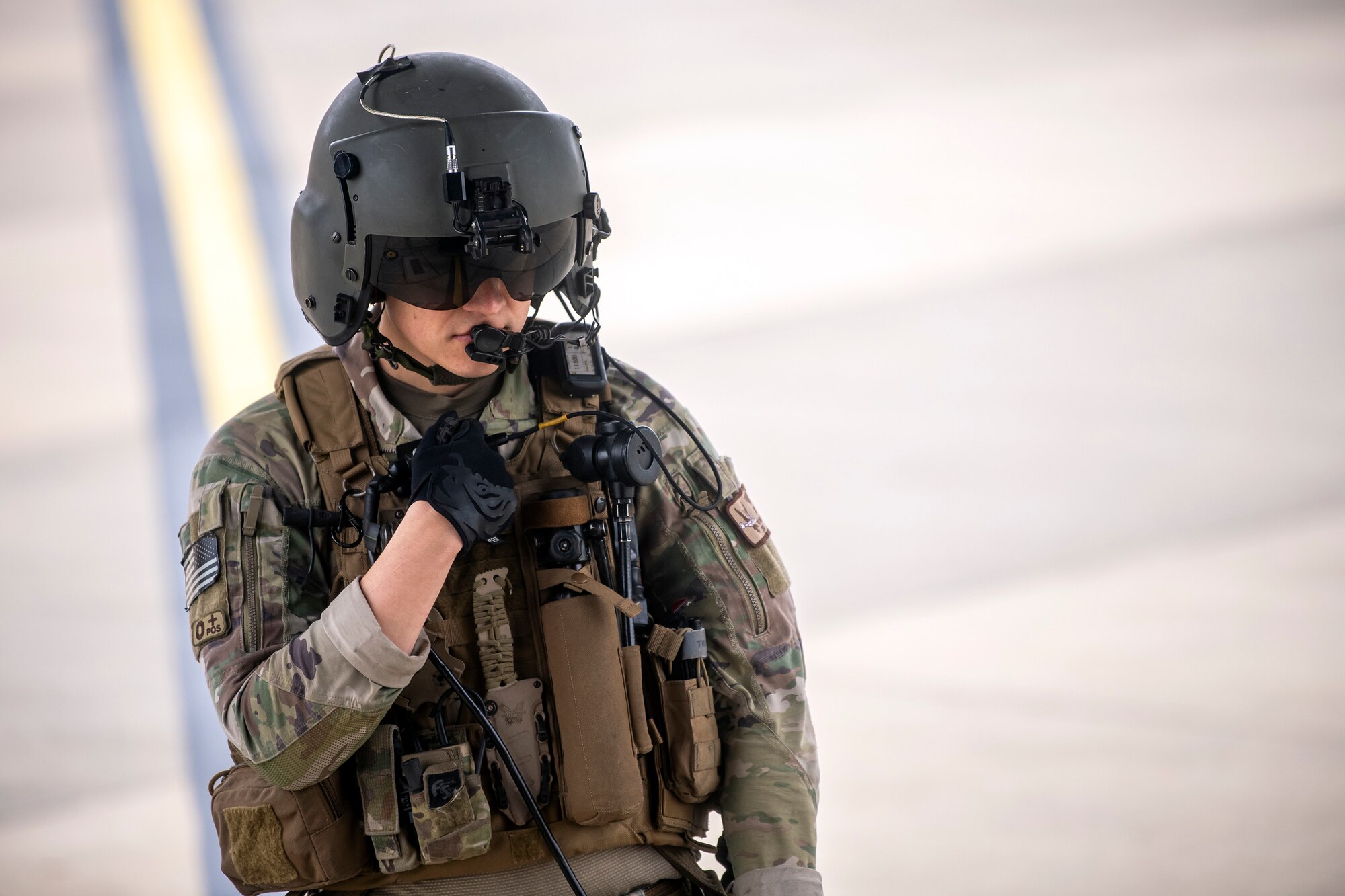 A Special Missions Aviator from the 352d Special Operations Wing communicates with his team at RAF Mildenhall, England, Nov. 11, 2022. The 352d SOW were preparing to conduct a flyover for the annual Veterans Day ceremony at Cambridge American Cemetery and Memorial. (U.S. Air Force photo by Staff Sgt. Eugene Oliver)