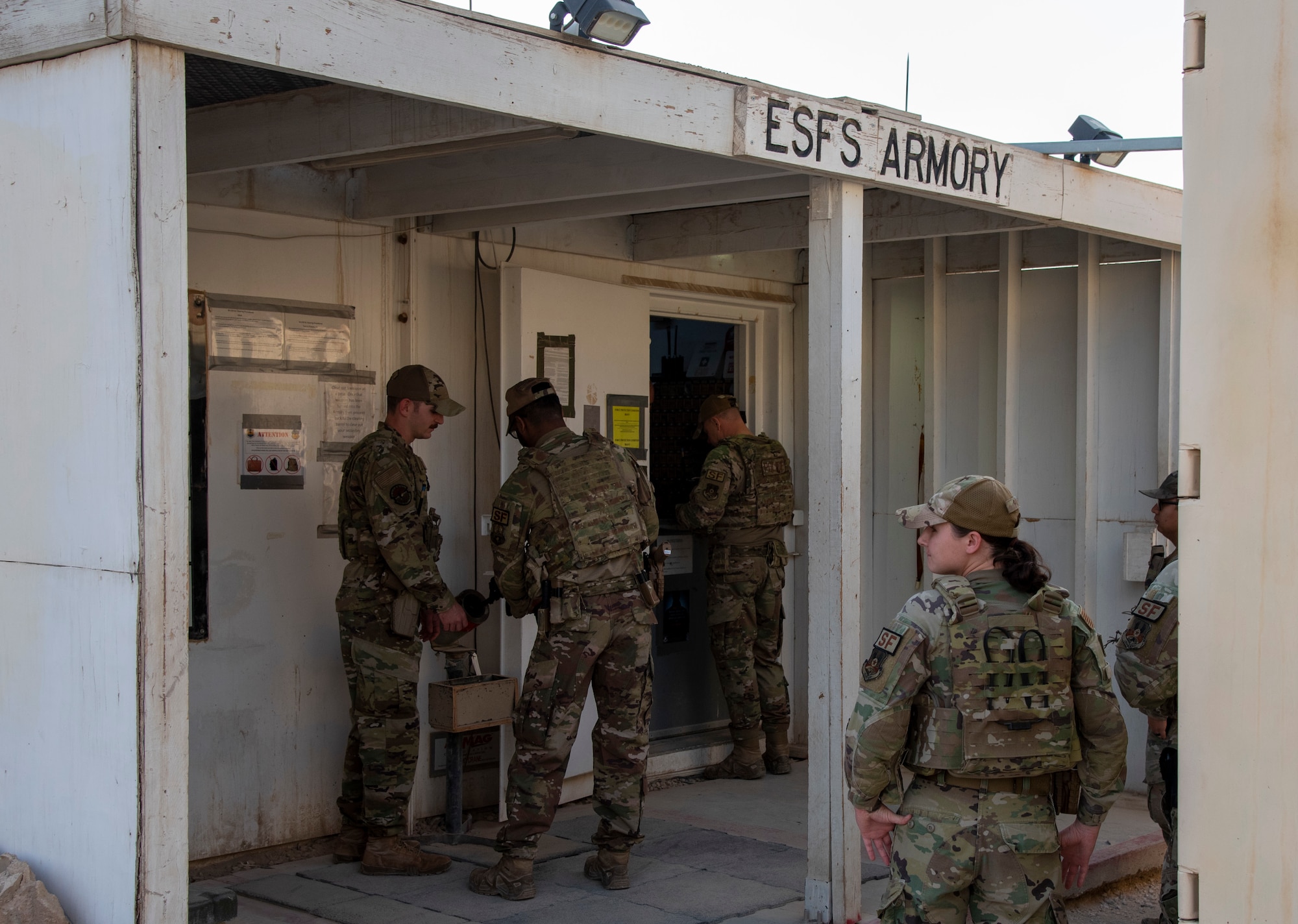 Members of the 332d Expeditionary Security Forces Squadron procure weapons from the Armory at an undisclosed location, Southwest Asia, Oct. 31, 2022. The 332d ESFS Armory provides all lethal and nonlethal weaponry used by Security Forces in base protection and combat operations. (U.S. Air Force photo by: Tech. Sgt. Jim Bentley)